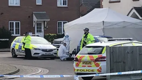 PA Media Police activity at Snowdonia Road, Walton Cardiff, Tewkesbury, after one man died and another suffered serious injuries during a series of stabbings.