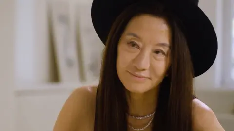 Vera Wang smiles, looking beyond the camera