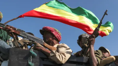 Reuters Armed fighters in a truck holding an Ethiopian flag