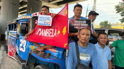 Protesters sitting on a jeepney