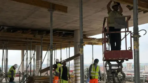 Builders at work on The Forum site.