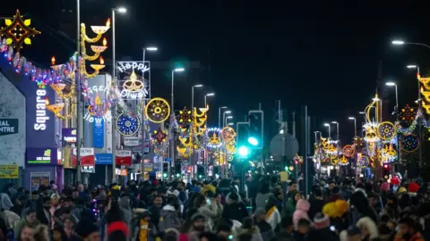 Beth Walsh Lights line the streets where there were huge crowds