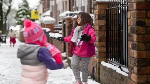 PA Media Children play with snowballs in Stoke-on-Trent, Staffordshire.
