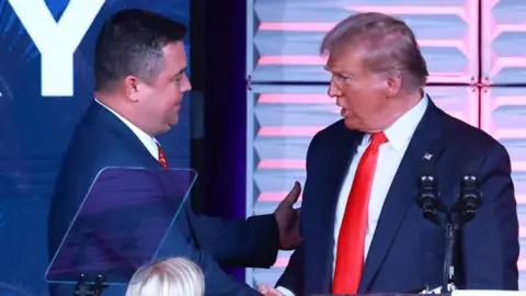 Getty Images Christian Ziegler shown with Donald Trump