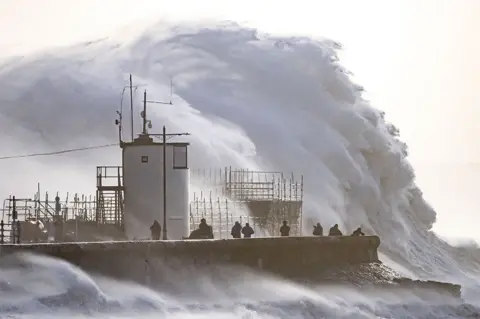 Getty Images Waves crash against the sea wall at Porthcawl, south Wales, on 18 February 2022