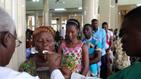 Getty Images Sunday morning catholic mass. Holy communion in Lome, Togo