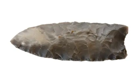 Getty Images A stone point made by the Clovis people.