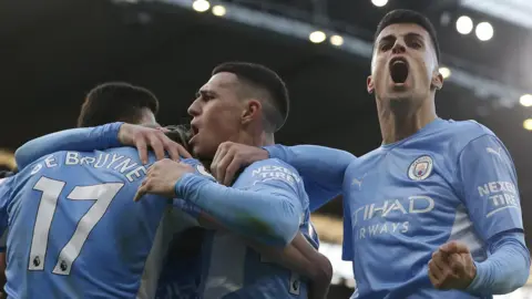 Manchester City players celebrate a goal in the 4-1 win against Manchester United