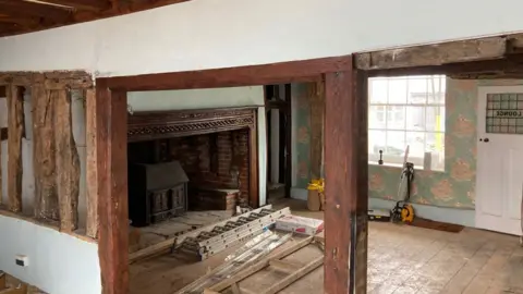 Luke Deal/BBC Inside The Red Lion, with the view of a fireplace and exposed beams