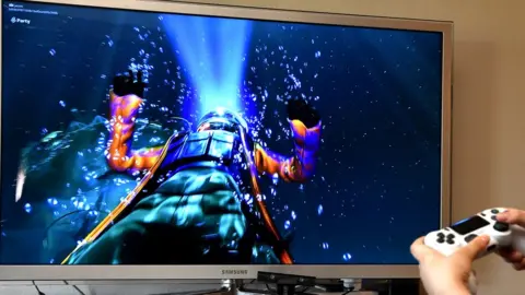Getty Images An underwater spacemen floats through the TV screen in front of the player