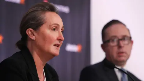 Getty Images Vanessa Hudson pictured at a press conference with Alan Joyce