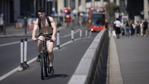 EPA A topless cyclist in London