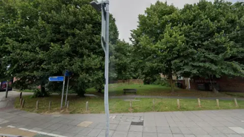 Google Area where pocket park will go, which currently has a bench and some grass