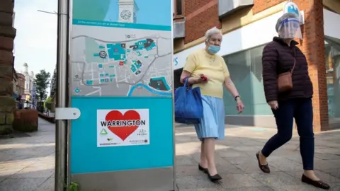 Reuters Women in masks in Warrington