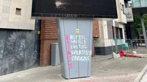 Graffiti reading Bristol Against Digital Advertising Screens on column