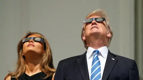 Getty Images The Trumps look at the sun