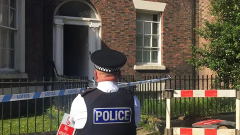 Eleanor Barlow/ PA Policeman outside the house in Falkner Street