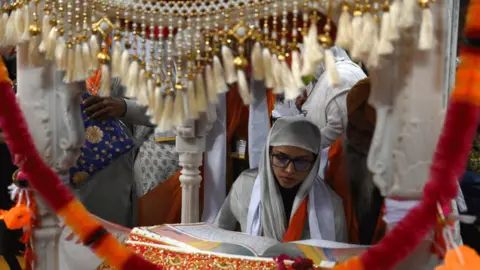 AFP Sikh pilgrims take part in a religious ritual as they gather to celebrate the 550th birth anniversary of Guru Nanak Dev, at Nankana Sahib