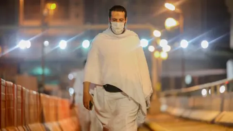 Reuters Muslim pilgrim wears a face mask during the Umrah pilgrimage on 3 October 2020