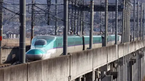 EPA The Tohoku shinkansen bullet train remains on the track after it derailed due to a strong earthquake in Shiroishi, Miyagi prefecture, north-eastern Japan, 17 March 2022.