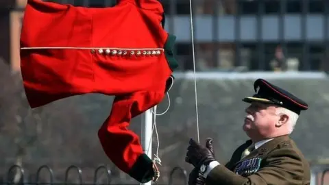 John Cotterill Red jacket being raised