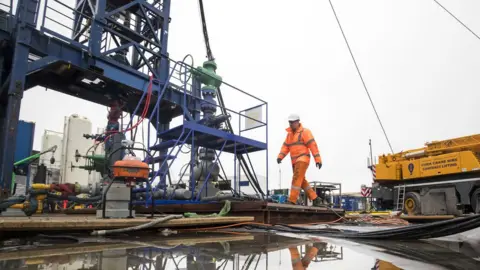 Danny Lawson/ PA Wire File photo dated 05/101/8 of a worker at the Cuadrilla fracking site in Preston New Road, Little Plumpton, Lancashire