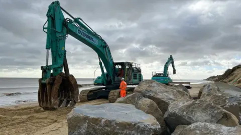 Martin Barber/BBC Rocks on the beach at Hemsby