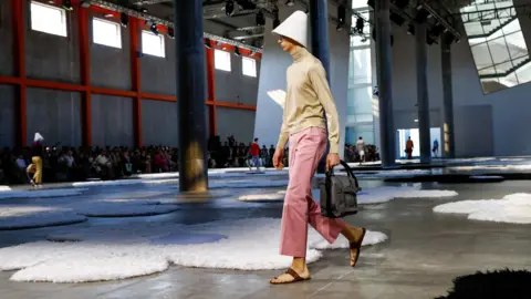 Reuters A model presents a creation from the Prada Spring-Summer 2026 menswear collection during the Milan Fashion Week in Milan, Italy, June 22, 2025