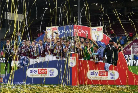 PA Media Burnley's Josh Brownhill and Jack Cork lift the Sky Bet Championship trophy after the Sky Bet Championship match at Turf Moor, Burnley.