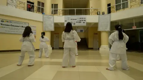 Children at Preda home take part in a karate session