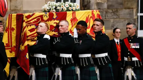 PA Media Soldiers carry the Queen's coffin