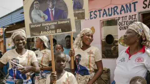 AFP Supporters hold placards before a campaign meeting of Amadou Ba, candidate of the Alliance For the Republic party (APR) in Diourbel, Senengal - 19 March 2024