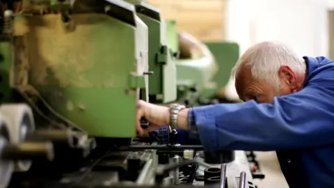 Getty Images Worker on factory machine