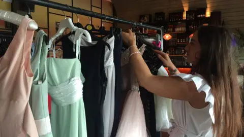 Chloe with some of the donated dresses