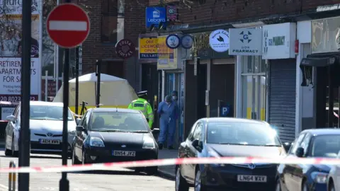 PA Forensics officers coming out of a shop in Marsh Road, Pinner