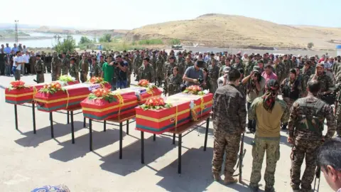 YPG Media Four coffins and a crowd of soldiers