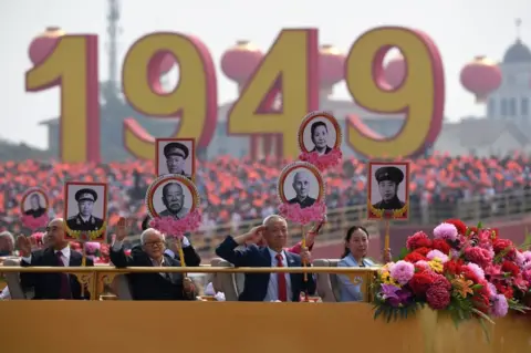 AFP Relatives of revolutionary martyrs take part in the National Day parade in Tiananmen Square in Beijing on October 1, 2019, to mark the 70th anniversary of the founding of the People's Republic of China.