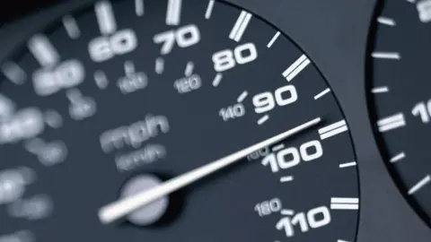 Getty Images A black and white car speedometer showing a speed of just under 100mph. 