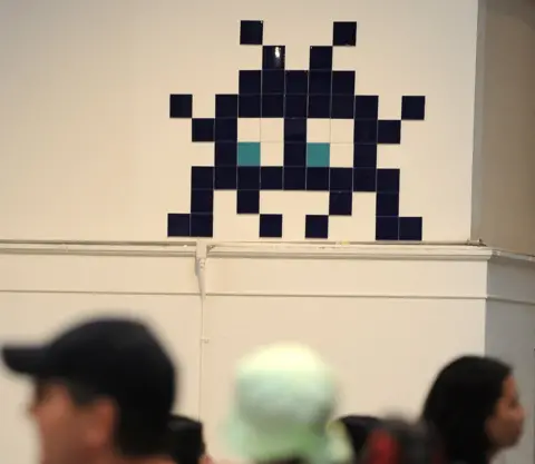 Getty Images A work by French street artist Invader is on display at the 'Art In The Streets' exhibition inside the Museum of Contemporary Art (MOCA) in Los Angeles in 2011.