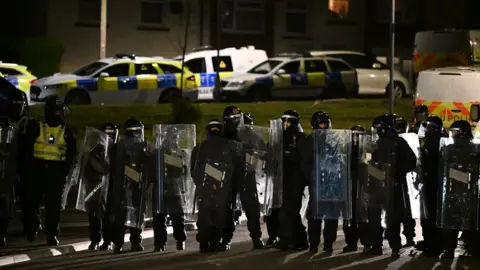 Getty Images Police in riot gear on Monday in Ely