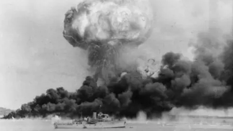 Australian War Memorial A ship in front of a plume of smoke