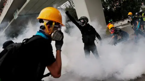 Reuters Demonstrators react to a tear gas during a protest against the Yuen Long attacks in Yuen Long, New Territories, Hong Kong, China July 27, 2019.