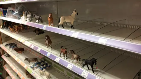 Shaun Whitmore/BBC Depleted shelves at the toy shop