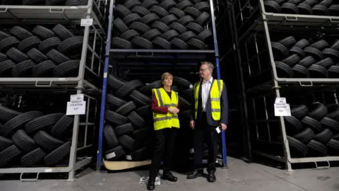 Getty Images Nicola Sturgeon with Michelin factory manager John Reid in June 2017