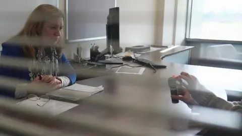 BBC Sarah demonstrates her SmartWater device to BBC correspondent June Kelly (l)