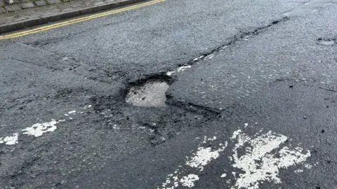 BBC A pothole on Railway Street in Chorley town centre
