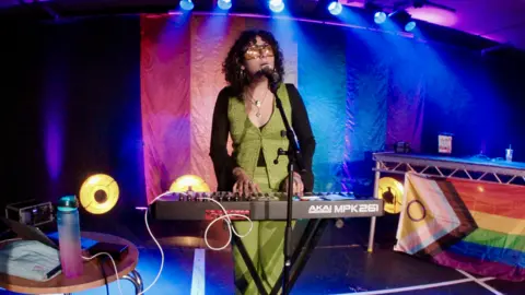 Curious Arts Singer playing keyboard