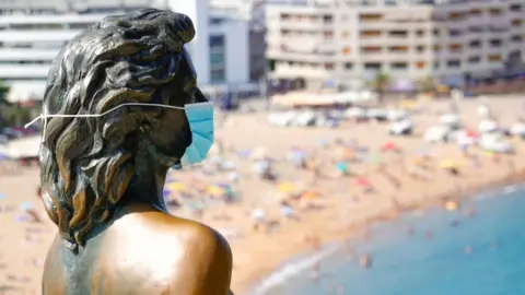 EPA A view of Ava Gardner"s statue wearing a protective face mask in Girona, Spain