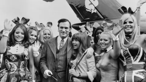 AFP Photo taken on August 30, 1970 shows US Playboy Magazine publisher Hugh Hefner (top), his girlfriend actress Barbara Benton and other playmates arriving at Le Bourget airport with the Playboy jet "Big Bunny"