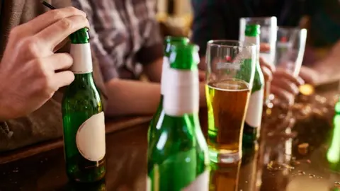 Getty Images Bottles of beer at bar